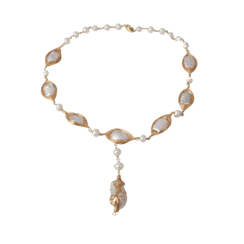 A luxurious handcrafted necklace featuring lustrous freshwater pearls intertwined with delicate copper wire. The unique design creates an elegant and modern look, ideal for adding sophistication to your outfit.